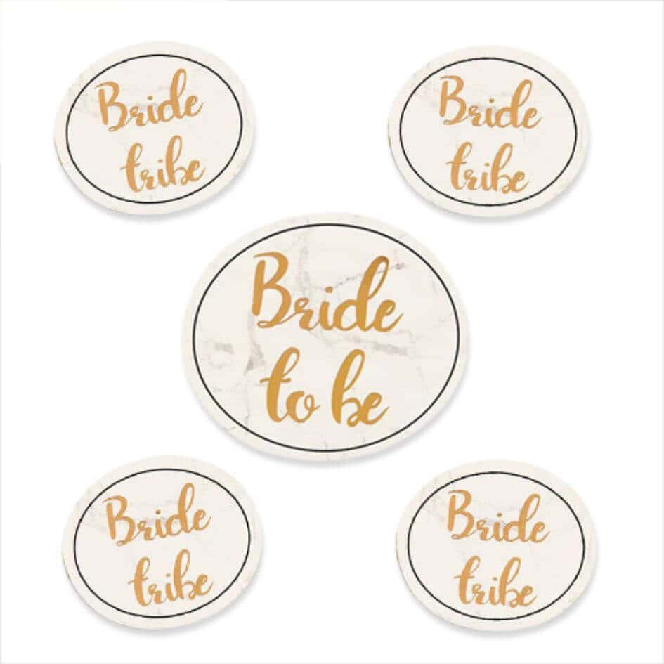 Bride To Be Badge Set from joke.ie Set of 5 stylish marble effect background with "Bride Tribe" printed in gold on 4 of them  and 1 larger badge with "Bride to be". Badges have a safety pin on the rear for easy attachment to your clothing.