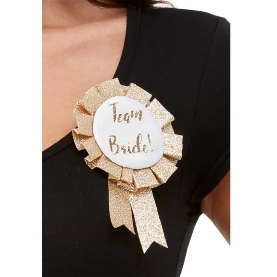 Team Bride Rosette Rose gold design team bride rosette with safety pink on the rear for easy attachment to your clothing.Checkout our full range of hen party novelty items.