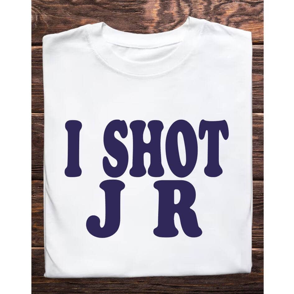 Father Ted Inspired: I Shot JR Tee Shirt from Joke.ie, Ireland. Celebrate your love for classic comedy with our Father Ted inspired I Shot JR tee shirt. Perfect for fans of the beloved television series, this unique tee captures the quirky humor and memorable moments that made Father Ted a timeless favorite. Whether you're heading to a comedy convention, relaxing at home, or hanging out with friends, this tee is a must-have addition to your wardrobe. Embrace the Quirkiness Nostalgic Design: The I Shot JR tee shirt features a playful design that pays homage to one of the most iconic and hilarious moments from Father Ted. The text, I shot JR, is prominently displayed, capturing the humor and charm of the show. This tee shirt is not just a piece of clothing; it's a conversation starter and a tribute to classic television comedy. High-Quality Materials Comfort and Durability: Made from a soft and breathable cotton blend, the I Shot JR tee shirt offers superior comfort for all-day wear. The durable fabric is designed to withstand repeated washing and wearing, ensuring that this tee remains a staple in your collection for years to come. The lightweight material makes it perfect for layering or wearing on its own, providing versatility for any season. Perfect Fit Unisex Sizing: Available in a range of unisex sizes, the I Shot JR tee shirt is designed to fit comfortably on both men and women. The classic crew neck and relaxed fit ensure that you look stylish while feeling comfortable. Transition seamlessly from casual outings to relaxed evenings at home with this versatile tee. Ideal for Various Occasions Versatile Style: Whether you're binge-watching Father Ted, attending a themed party, or just enjoying a casual day out, this tee shirt is the perfect choice. Its simple yet eye-catching design makes it suitable for a variety of occasions, allowing you to showcase your love for the show wherever you go. Great Gift Idea: Looking for a unique gift for a Father Ted fan? The I Shot JR tee shirt is an excellent choice. Its nostalgic design and high-quality construction make it a thoughtful and memorable gift for birthdays, holidays, or just because. Easy Care Low Maintenance: The I Shot JR tee shirt is easy to care for, requiring minimal effort to keep it looking its best. Simply machine wash in cold water and tumble dry on low heat to maintain the vibrant print and comfortable fabric. This Father Ted inspired tee shirt is a must-have for fans of the show. Its nostalgic design, high-quality materials, and versatile style make it the perfect addition to any wardrobe. Celebrate Your Love for Classic Comedy with this unique and stylish tee shirt, and bring a touch of Father Ted humor to your everyday life. Colour: White loose fit tee Size: Small 35/37″ Medium 38/40″ Large 41/43″ X Large 44/46″ 2X Large 47/49″ 3X Large 50/522 View our entire Father Ted Collection here.