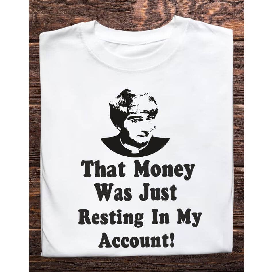 Father Ted Themed: "Resting in My Account" Tee Shirt from Joke.ie, Ireland. Celebrate the iconic humor of Father Ted with our "Resting in My Account" Tee Shirt. Perfect for fans who appreciate the show's unique brand of comedy, this tee captures one of Father Ted's most memorable and oft-quoted lines. Design and Style The Resting in My Account Tee Shirt features a striking black-and-white image of Father Ted, perfectly capturing his classic expression. Below the image, the phrase "That Money Was Just Resting in My Account" is printed in a bold, eye-catching font. This design pays homage to one of the series' most infamous moments, making it an instant favorite for any fan. Material and Comfort Crafted from cotton, this tee shirt offers superior comfort and durability. The soft, breathable fabric ensures a cozy fit, perfect for everyday wear or special occasions. The tee maintains its shape and size even after multiple washes, providing long-lasting enjoyment. Humorous and Nostalgic Wearing the Resting in My Account Tee Shirt is a delightful way to celebrate the witty and memorable humor of Father Ted. The design evokes laughter and fond memories of the show's classic moments, particularly Father Ted's hilarious attempts to explain away his financial indiscretions. It's a subtle yet effective way to showcase your love for the series and connect with fellow fans. Versatile and Stylish This tee shirt pairs well with jeans, shorts, or even pajama bottoms for a relaxed, casual look. Its classic fit makes it suitable for any occasion, whether you’re heading to a comedy night, hanging out with friends, or simply relaxing at home. The humorous design ensures you'll stand out and spark conversations wherever you go. Perfect Gift for Fans Looking for the perfect gift for a Father Ted aficionado? The "That Money Was Just Resting in My Account" Tee Shirt is an excellent choice. Its unique design and high-quality construction make it a thoughtful and enjoyable present for birthdays, holidays, or any special occasion. Celebrate the wit and nostalgia of Father Ted with the "That Money Was Just Resting in My Account" Tee Shirt. Featuring the iconic line and image of Father Ted, this shirt is a must-have for any fan of the show. Enjoy the comfort of premium cotton and the joy of sharing your favorite TV moments with the world. Get your "That Money Was Just Resting in My Account" Tee Shirt today and add a touch of Craggy Island humor to your wardrobe! Colour: White loose fit tee Size: Small 35/37″ Medium 38/40″ Large 41/43″ X Large 44/46″ 2X Large 47/49″ 3X Large 50/522 View our entire Father Ted Collection here.