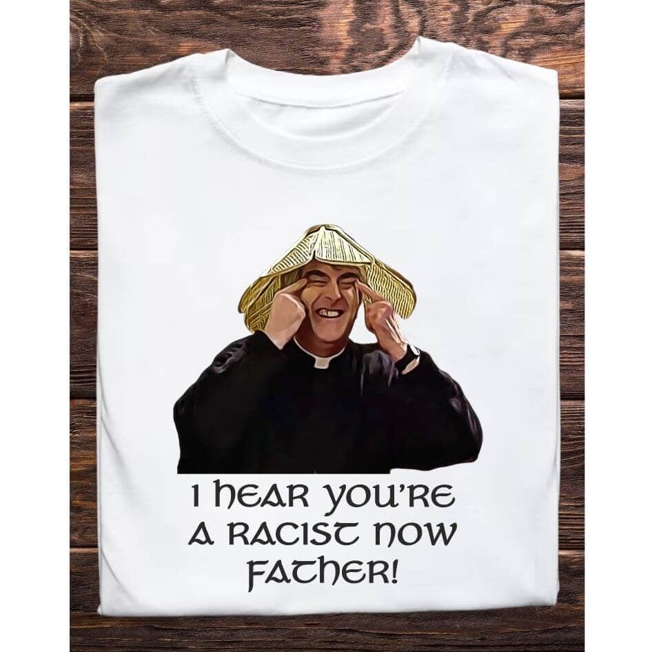 Father Ted Themed "I Hear You're a Racist Now, Father" Tee Shirt Step into the world of Father Ted with our I Hear You're a Racist Now Father Tee Shirt, featuring one of the most controversial yet unforgettable scenes from the show. Perfect for fans who appreciate the bold humor and satirical edge of the series, this t-shirt is a standout piece for any wardrobe. Design and Style The I Hear You're a Racist Now Father Tee Shirt captures the essence of Father Ted's satirical comedy with a striking design. The shirt features an image of Father Ted pulling his eyes, a moment that is as controversial as it is memorable. Below the image, the phrase "I Hear You're a Racist Now, Father" is printed in a bold, eye-catching font. This design pays homage to one of the series' most talked-about scenes, making it a conversation starter and a nostalgic piece for fans. Material and Comfort Crafted from high-quality, 100% cotton, this t-shirt ensures superior comfort and durability. The soft, breathable fabric provides a cozy fit, perfect for everyday wear or special occasions. It maintains its shape and size even after multiple washes, ensuring long-lasting wear. Humorous and Nostalgic Wearing the "I Hear You're a Racist Now, Father" T-Shirt is a way to celebrate the edgy humor of Father Ted. The design brings to life a scene that, while controversial, highlights the show’s ability to tackle sensitive subjects with its unique brand of humor. It's a subtle yet impactful way to show your appreciation for the series and its daring comedic style. Versatile and Stylish This t-shirt pairs well with jeans, shorts, or even pajama bottoms for a relaxed, casual look. Its classic fit makes it suitable for any occasion, whether you’re heading to a comedy show, hanging out with friends, or simply relaxing at home. The bold design ensures you'll stand out and make a statement wherever you go. Perfect Gift for Fans Looking for the perfect gift for a Father Ted aficionado? The I Hear You're a Racist Now Father Tee Shirt is an excellent choice. Its unique design and high-quality construction make it a thoughtful and enjoyable present for birthdays, holidays, or any special occasion. Celebrate the daring humor and memorable moments of Father Ted with the I Hear You're a Racist Now Father Tee Shirt. Featuring the controversial yet iconic scene of Father Ted, this shirt is a must-have for any fan of the show. Enjoy the comfort of premium cotton and the joy of sharing your favorite TV moments with the world. Get your "I Hear You're a Racist Now, Father" T-Shirt today and add a touch of Craggy Island satire to your wardrobe! Colour: White loose fit tee Size: Small 35/37″ Medium 38/40″ Large 41/43″ X Large 44/46″ 2X Large 47/49″ 3X Large 50/522 View our entire Father Ted Collection here.