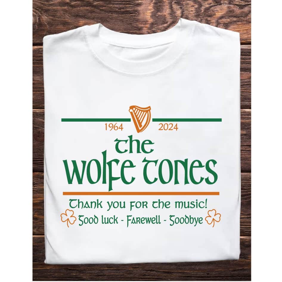 The Wolfe Tones Tee from Joke.ie Celebrate the rich legacy of The Wolfe Tones with this beautifully designed commemorative T-shirt, perfect for any fan of Irish music. This exclusive T-shirt captures the essence of the band's 60-year journey, blending meaningful symbols with a classic, stylish design that honors their incredible contribution to Irish culture. Design Features: At the heart of this T-shirt is a striking vector harp, rendered in a vibrant orange-gold. The harp, a symbol of Ireland and its musical heritage, is prominently placed to represent the timeless influence of The Wolfe Tones. Flanking the harp are the years "1964 - 2024," marking the first and last years of the band’s tours, signifying their six decades of musical excellence. Beneath the harp, "The Wolfe Tones" is boldly displayed in green, a color that resonates with Irish pride. This central text is a tribute to the band's enduring presence in the world of folk music. Just below this, the words "Thank You for the Music!" express heartfelt gratitude for the countless memories and songs that have shaped generations. To complete the design, the iconic phrase "Good Luck - Farewell - Goodbye" is elegantly printed at the bottom, reflecting the band's traditional sign-off at their concerts. This phrase is accompanied by two orange-gold shamrocks, adding a touch of Irish charm and luck to the design. Quality and Comfort: Crafted from high-quality, soft cotton, this T-shirt is as comfortable as it is symbolic. Available exclusively in white, the design stands out with vibrant colors and sharp details, making it a perfect choice for everyday wear or as a collector's item. Range of Sizes: Understanding that Wolfe Tones fans come in all shapes and sizes, this T-shirt is available in a full range of sizes, from XS to XXXL. Whether you’re a long-time fan or new to their music, this T-shirt is a perfect way to celebrate and honor The Wolfe Tones' legendary journey. Shop our full concert collections here! Size: Adults Small 36″ Medium 40″ Large 44″ X Large 48″ 2X Large 52″