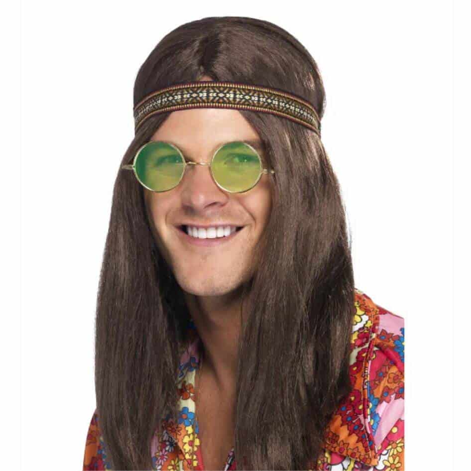 Men’s Hippie Kit from Joke.ie: Channel Your Inner 60s Vibe Elevate your festival or retro party look with this Mens Hippie Kit, a complete ensemble that channels the free-spirited vibe of the 1960s. Designed for those who want to embody the essence of peace, love, and harmony, this kit includes three iconic accessories: a headband, specs, and a necklace with a medallion. High-Quality Headband The headband in this kit is crafted from soft, comfortable fabric, ensuring a snug fit that stays in place throughout your day. With its vibrant, tie-dye pattern, the headband instantly captures the eye, giving you that unmistakable hippie look. Whether you're wearing your hair long and loose or styled in a classic shag, this headband is the perfect finishing touch to your retro ensemble. Authentic Vintage Specs Moreover, the specs included in this kit are a standout feature. With their round frames and tinted lenses, these specs not only shield your eyes from the sun but also add an authentic, vintage flair to your outfit. The lightweight design ensures comfort, allowing you to wear them for hours without any discomfort. Durable Necklace with Symbolic Medallion Finally, the necklace with a medallion is the centerpiece of our mens hippie kit. The medallion, emblazoned with a peace sign, is a symbol of the era’s ideals and a bold statement piece that ties the whole look together. The chain is designed to be durable yet lightweight, making it easy to wear while you dance, sing, or simply enjoy the moment. Complete Your Look This Mens Hippie Kit provides everything you need to embody the iconic style of the 1960s. With its vibrant headband, retro specs, and symbolic necklace, this kit ensures you’ll stand out in any crowd, spreading good vibes wherever you go. Order your kit today and step into a world of peace, love, and groovy fun! Shop our full accessories collection here!