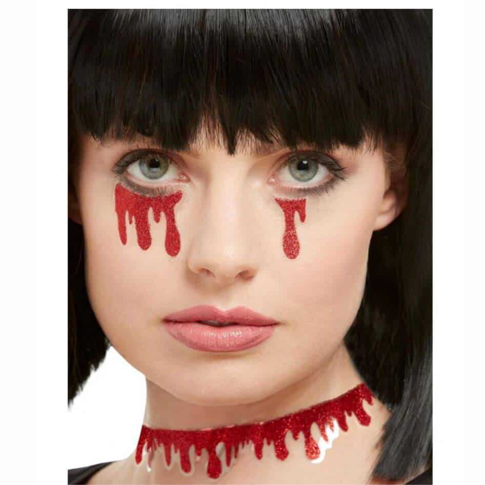 Blood Dripping Stickers m Joke.ie, Ireland: Add a Dramatic Touch to Your Look Transform your appearance with these Blood Dripping Stickers, designed to create a bold and eerie effect under your eyes and on your throat. Perfect for Halloween, cosplay, or any event where you want to stand out, these stickers are easy to apply and make a lasting impression without the need for glue. Easy Application - No Glue Required Applying these Blood Dripping Stickers couldn’t be easier. Unlike traditional face decals that require messy adhesives, these stickers come ready to use with a self-adhesive backing. Simply peel them off the sheet, position them under your eyes, and press gently. Same applies for the throat sticker! They adhere smoothly to your skin and stay in place throughout your event, making your look both dramatic and hassle-free. Realistic Blood Drip Design The stickers feature a realistic blood drip design that flows naturally from the corners of your eyes. The deep red color and carefully crafted drip shapes mimic the look of real blood, adding an intense, chilling effect to your makeup. Whether you’re aiming for a vampire, zombie, or any other ghastly character, these stickers provide the perfect finishing touch. Sparkling Finish for Added Drama What sets these Blood Dripping Stickers apart is the subtle sparkle embedded in the design. This glittery finish catches the light as you move, adding an unexpected and striking contrast to the dark, bloody appearance. The sparkle enhances your overall look, giving it a unique and eye-catching twist. Comfortable and Long-Lasting Despite their bold appearance, these stickers are comfortable to wear. The lightweight material allows them to blend seamlessly with your skin, so you can enjoy your night without irritation. Plus, they are long-lasting, ensuring they stay put until you’re ready to remove them. Perfect for Any Occasion Whether you’re gearing up for a haunted house, costume party, or just want to add a spooky touch to your makeup, these Blood Dripping Stickers are the ideal accessory. With their easy application, realistic design, and sparkling finish, they’re sure to make you the center of attention.
