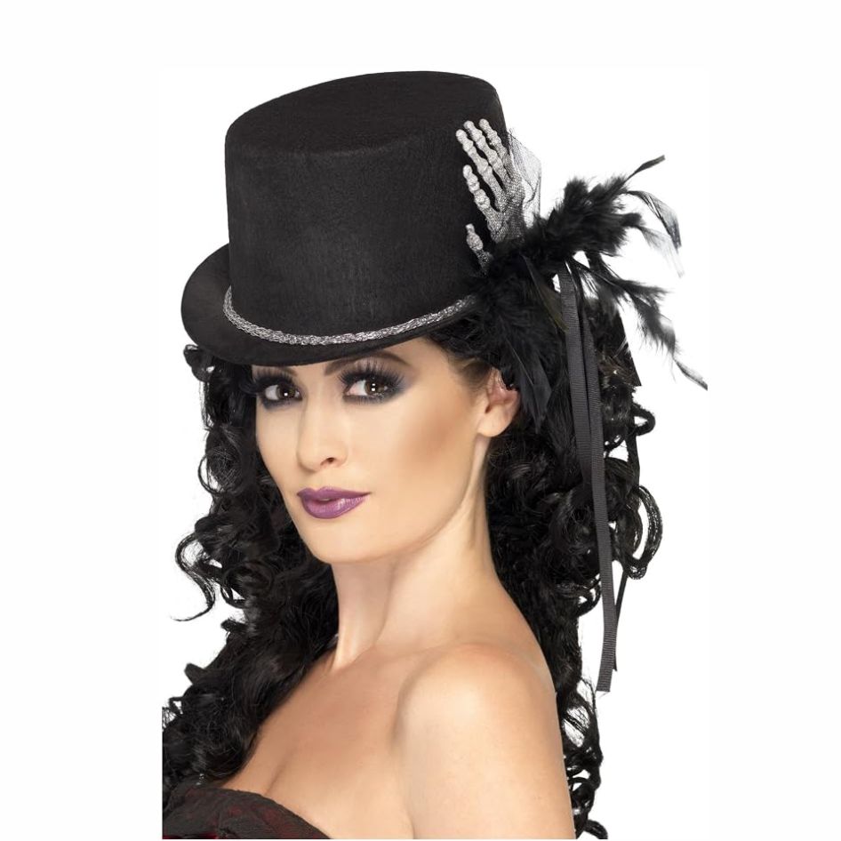 Top Hat With Skeleton Hands from joke.ie Black Skeleton Hand Top Hat with Feathers & Silver Detail Make a striking entrance with this dramatic Black Skeleton Hand Top Hat, an eye-catching fancy dress accessory combining gothic glamour with a wonderfully spooky finish. The classic black felt-style hat features a skeleton hand on the side, shimmering silver beading and dark feathers, creating an elegant look with a macabre twist. The deep black colouring provides the perfect backdrop for the contrasting skeletal decoration and sparkling silver details. Feathers add texture and theatrical flair, giving the hat a distinctive appearance that can instantly transform a simple costume. The statement skeleton hand provides a creepy finishing touch without overwhelming the overall design. Ideal for Halloween fancy dress, gothic costumes, spooky parties, themed nights and seasonal celebrations, this top hat can complement a wide variety of characters. Team it with a skeleton outfit, Victorian gothic costume, vampire look, dark ringmaster ensemble or your own creative Halloween style. Easy to coordinate with black clothing and dramatic accessories, this skeleton hand top hat is a great choice when you want one standout piece to complete your costume. The combination of classic top hat styling, black felt, silver beading, feathers and skeletal detailing creates a memorable accessory with plenty of dark character and theatrical appeal. One Size